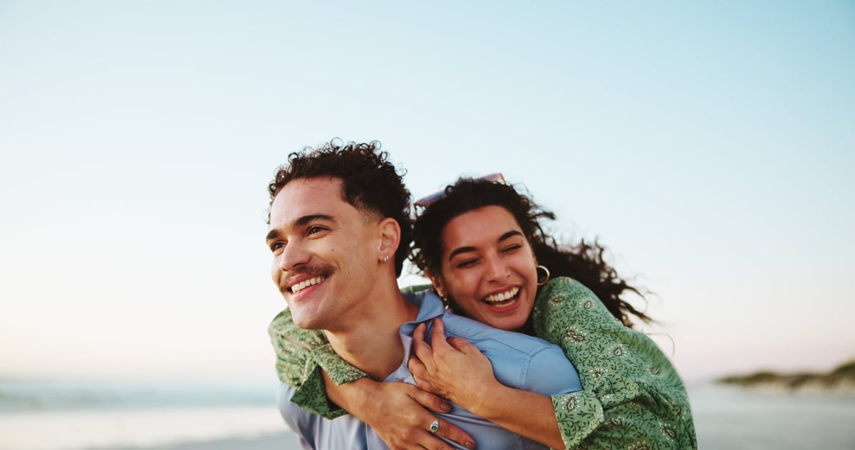 Couple laughing together at the beach
